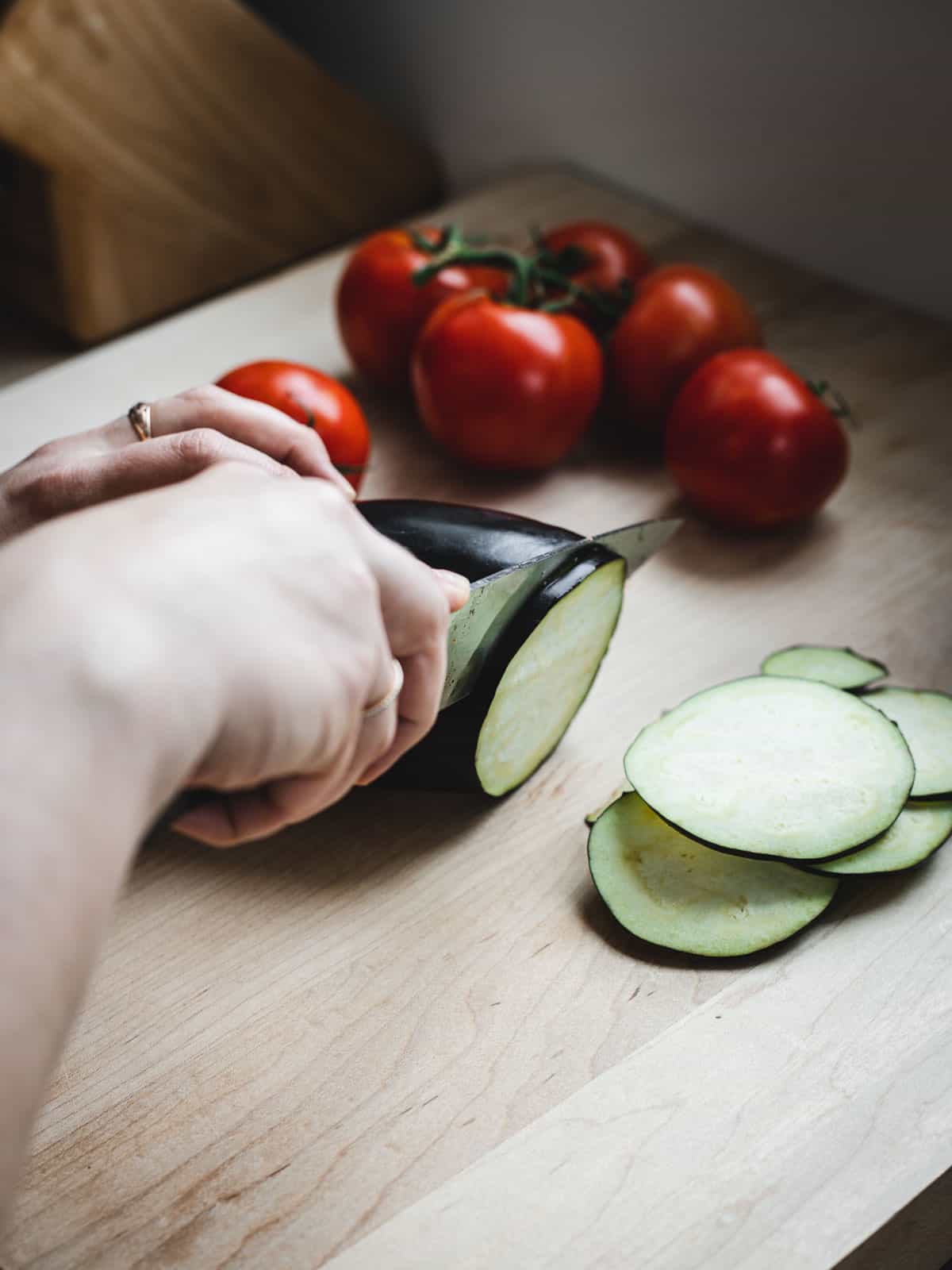 slicing eggplants and tomatoes