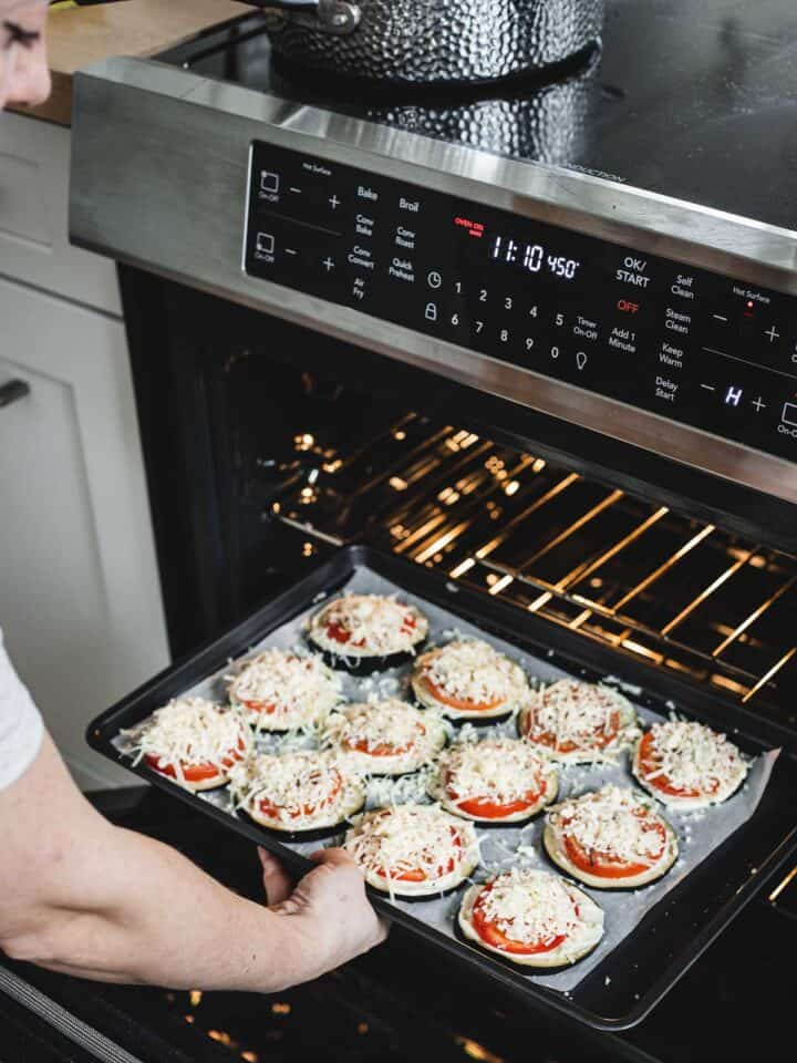 placing unbaked eggplants with cheese on baking sheet