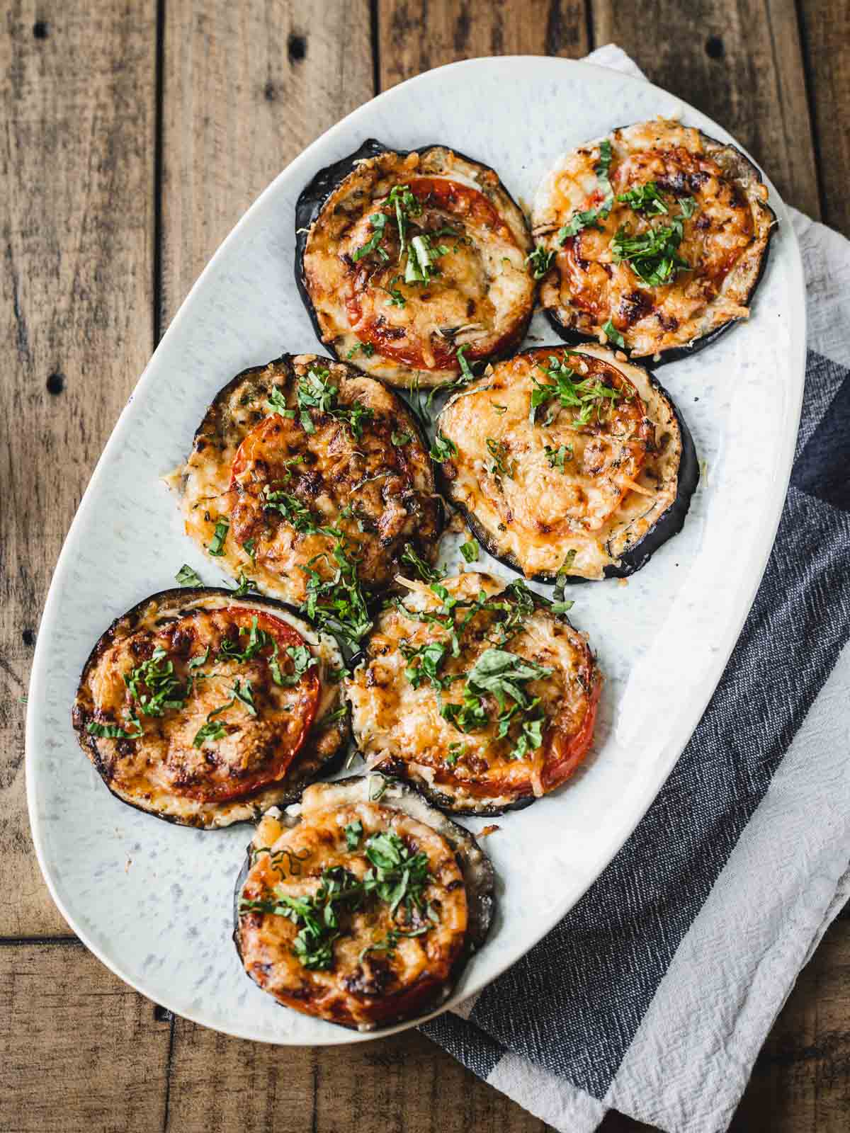 baked eggplant tomato stacks on oval plate