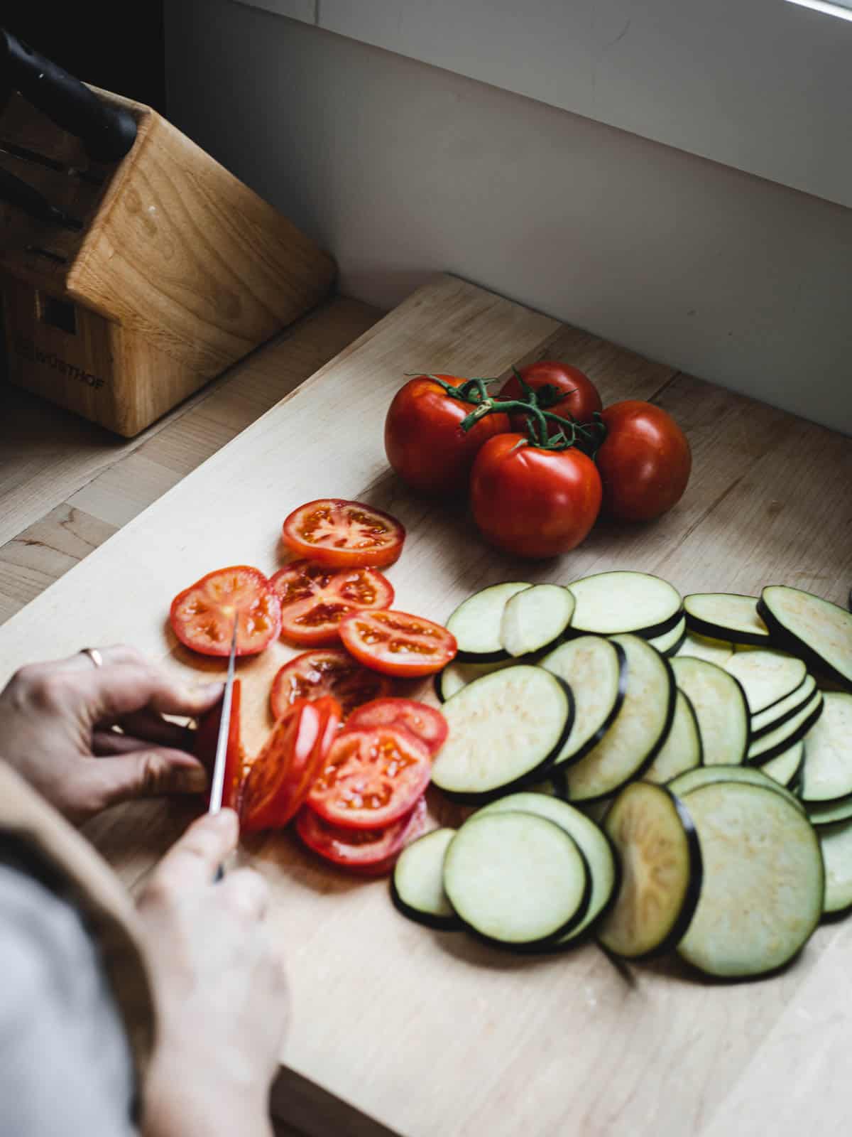slicing eggplants and tomatoes