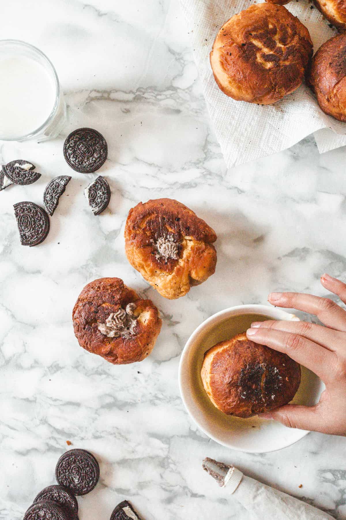 Dipping sufganiyot into ganache