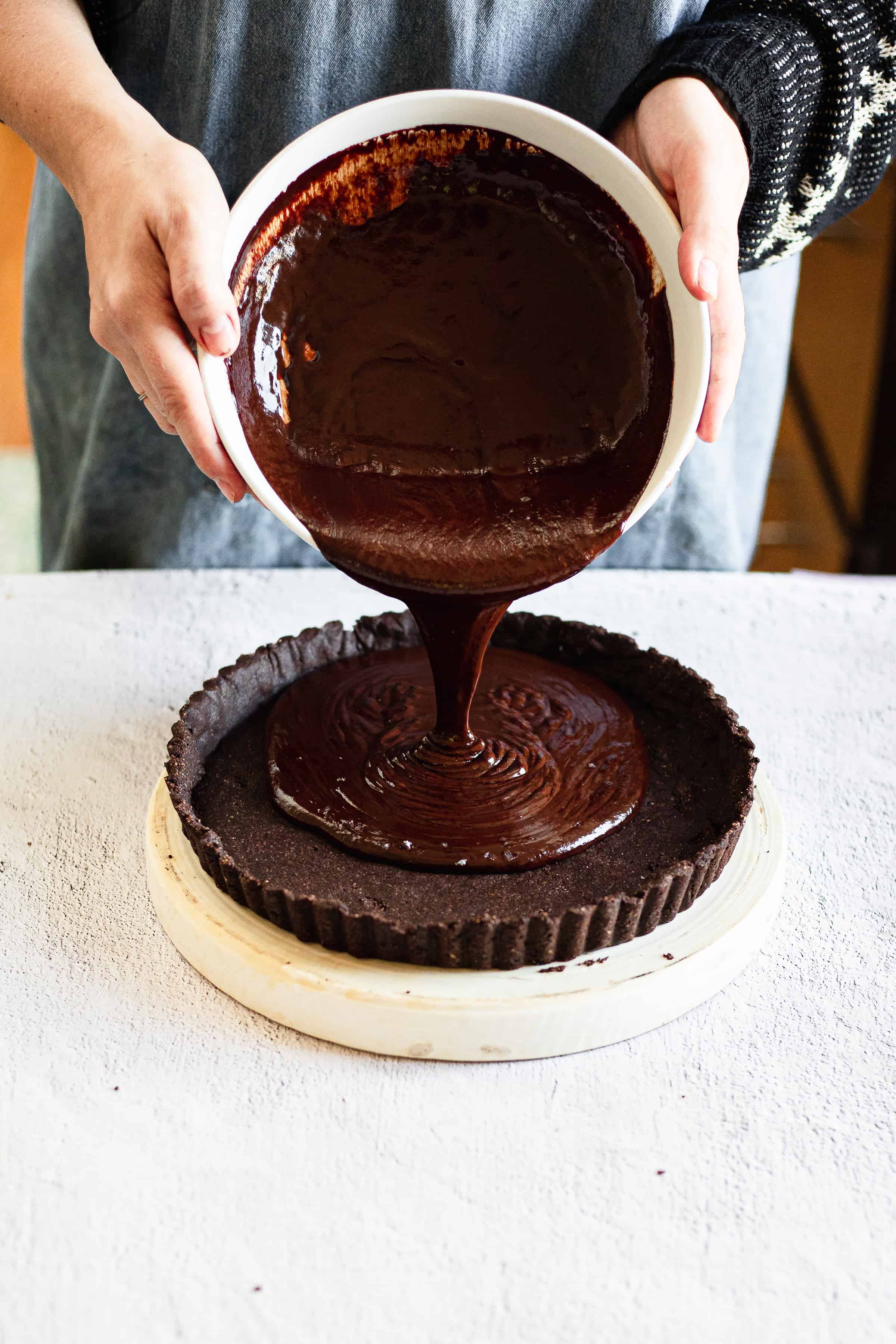 pouring ganache into tart crust
