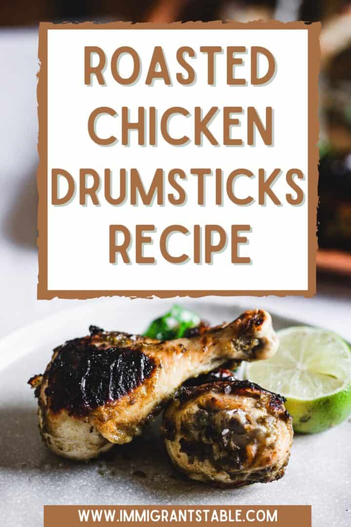 two roasted chicken legs with lime on a plate