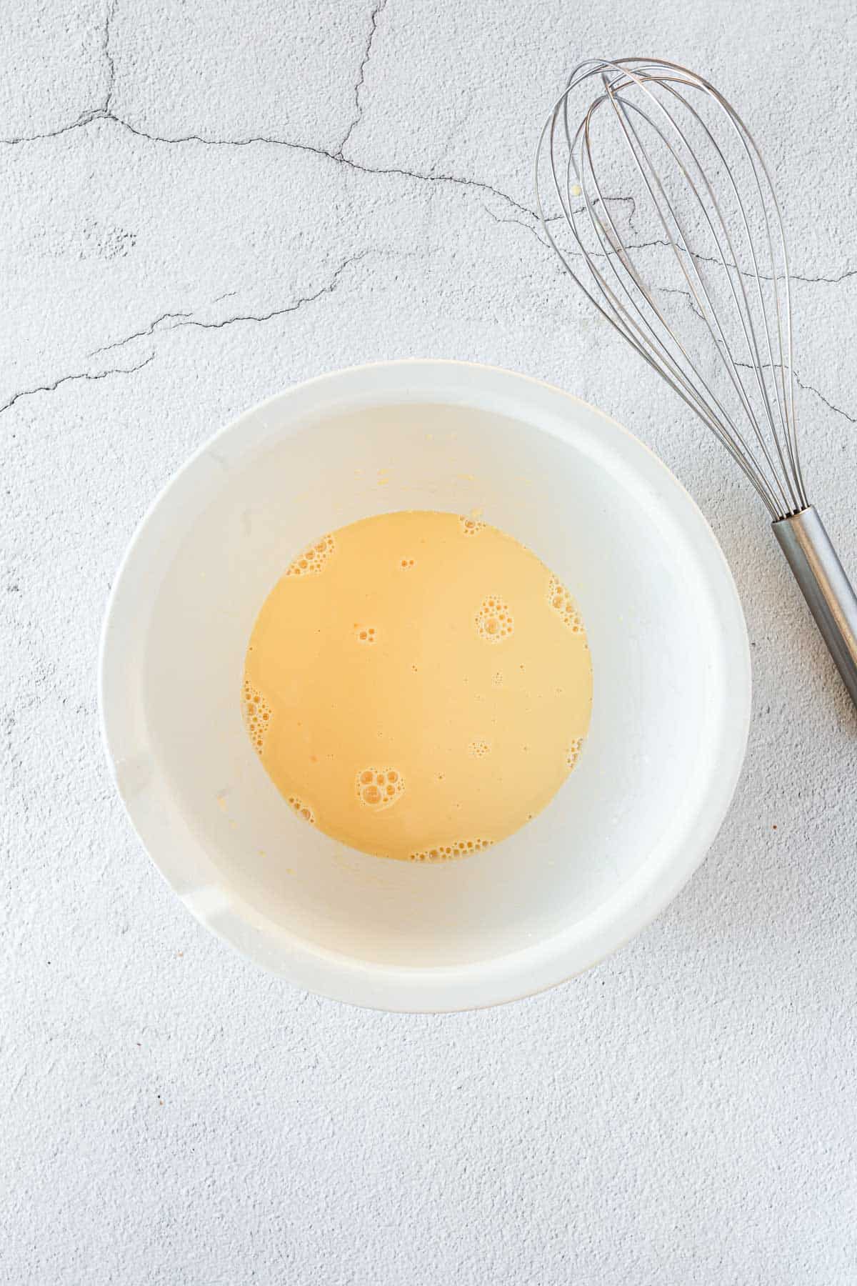 muffin batter in bowl with whisk