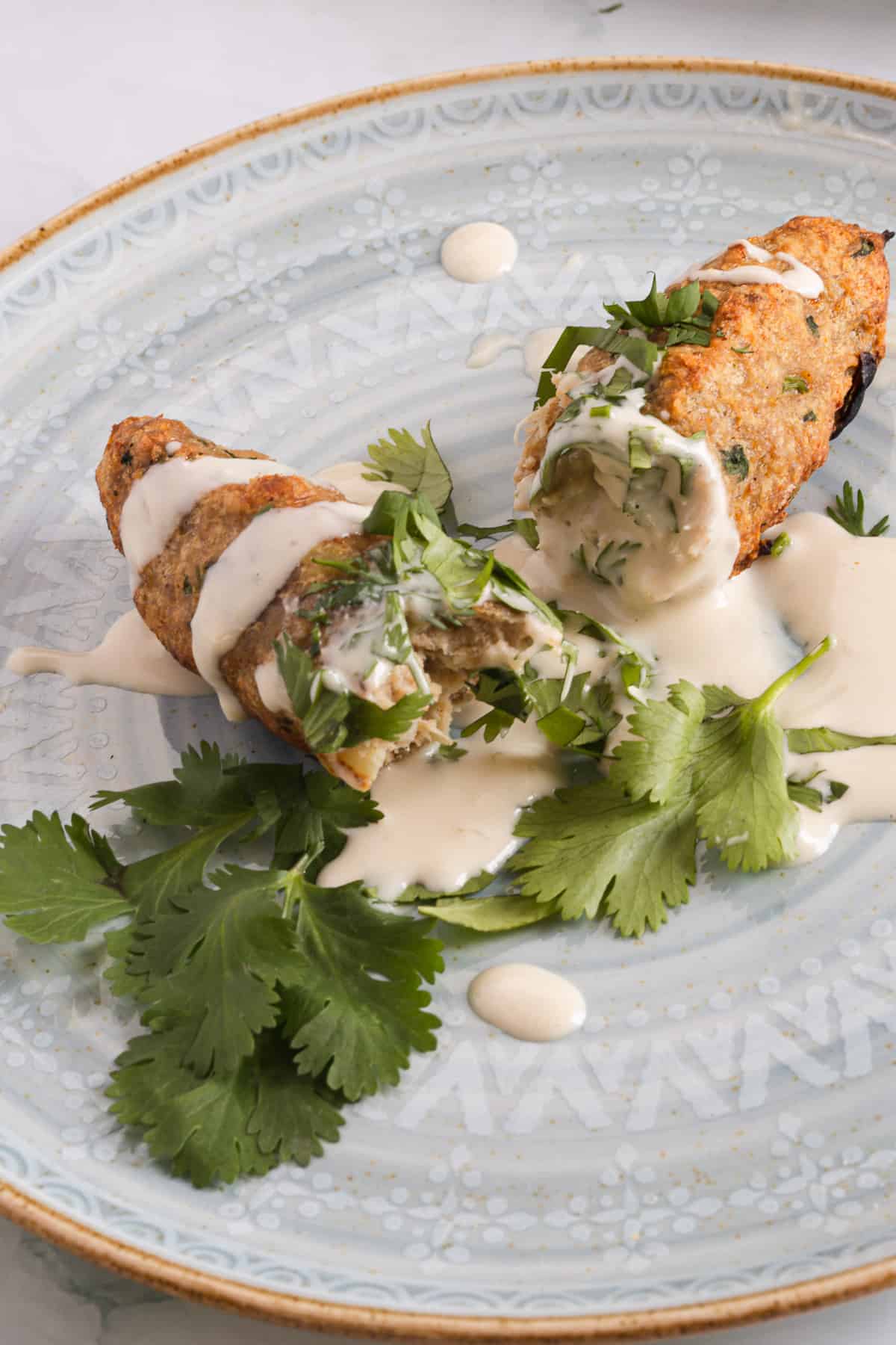 Two kebab halves on a plate.